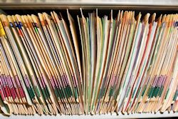 Medical records on a shelf.