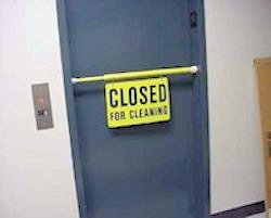 Door with a closed for cleaning sign across it.