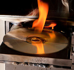 A CD in a computer that is on fire.