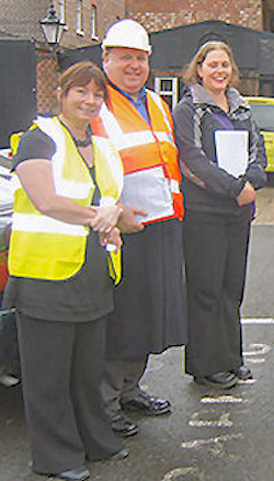 Three evacuation coordinators checking the plan.