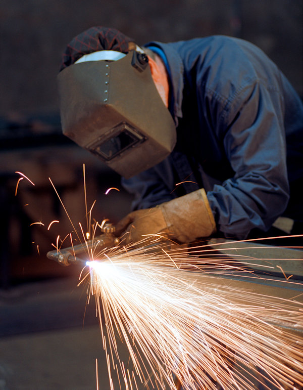 welder working with PPE and sparks flying