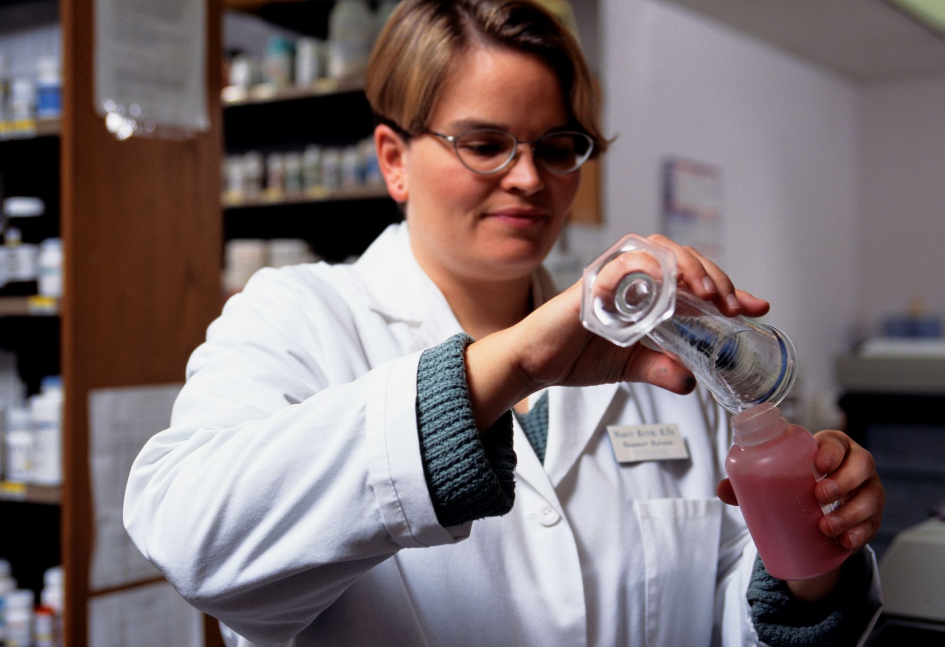 Pharmacist handling chemicals.