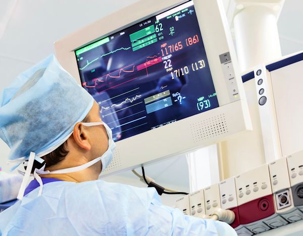 Healthcare worker looking at a monitor.