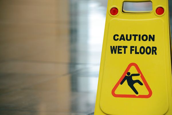 A Caution Wet Floor sign on a floor.