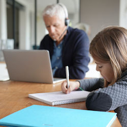 Image showing an adult and child sitting at a table working from home