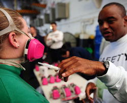 Image showing two employees one giving the other a respirator fit test