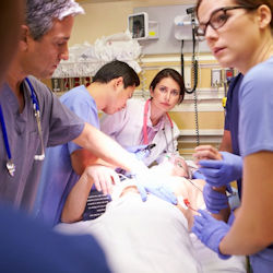 Emergency room workers surrounding patient