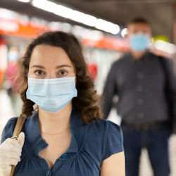 Two people walking maintaining safe social distancing.