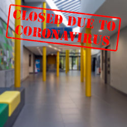 A picture of an empty school hallway with red text that says Closed Due to Coronavirus