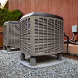 two air conditioner condensers outside a building