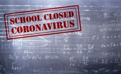 A chalkboard that has red block letters on it that says, 'School Closed Coronavirus' superimposed on top