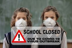 Two girls in school uniforms are wearing face masks. There is a message stating 'School Closed due to COVID-19 Virus Outbreak' superimposed over the image.