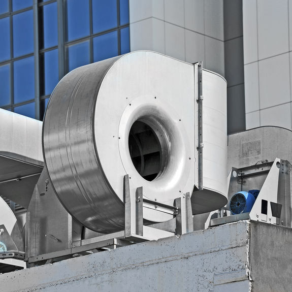 Outdoors on a roof is an industrial steel air conditioning and ventilation system.