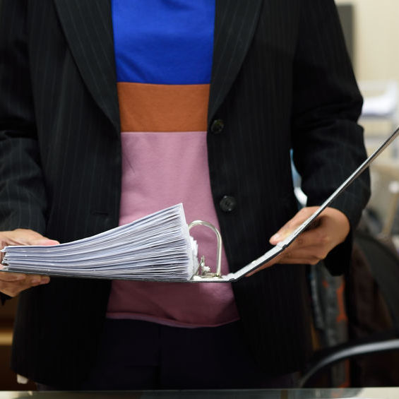 Person looking down at an open binder.