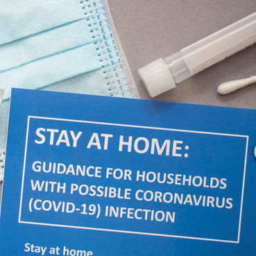 A 'COVID-19 Stay at Home' flyer.