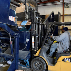 Forklift with driver in a recycling facility.