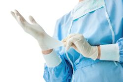 Healthcare provider wearing scrubs and PPE.