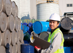 inspector checking stacks of metal containers