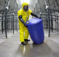 PPE clothed worker moving a barrel