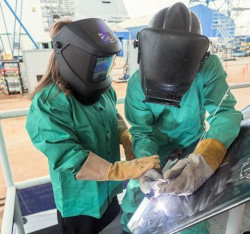 Two workers with face shields to protect eyes from UV radiation