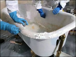 workers using methylene chloride to strip surface of bathtub