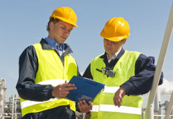 Two workers evaluating the on-site conditions