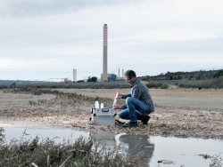 Worker collecting water samples from the perimeter