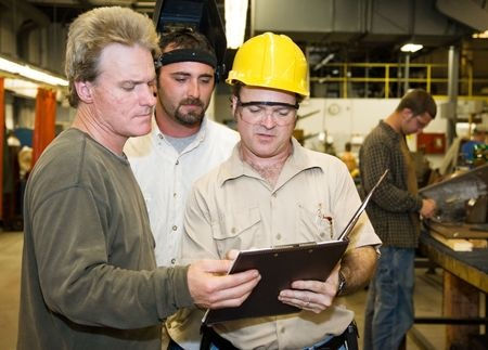 workers reviewing clipboard