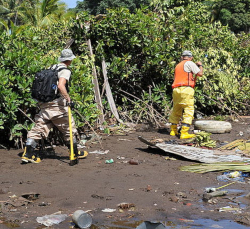 Two workers preparing a site for cleanup