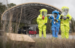 Three workers monitoring for hazardous atmospheres