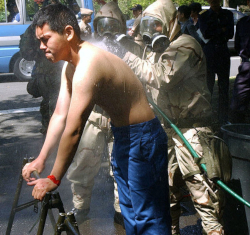 Worker with no protective clothing being decontaminated