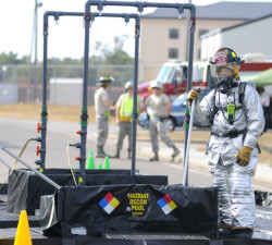 Worker standing next to decontamination equipment