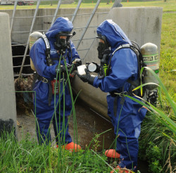 workers in chemical protective clothing outside of confined space