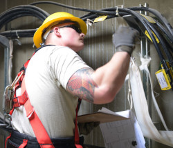 employee inspecting electrical equipment