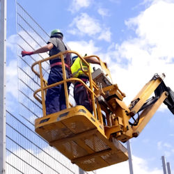 Two workers in an aerial lift