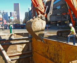 competent person wearing fall protection overseeing trench work