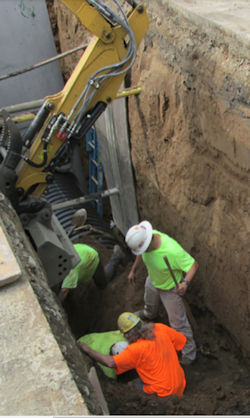 workers in trench to rescue buried employee