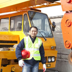 worker next to mobile crane