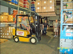 forklift in a warehouse safely lifting a load