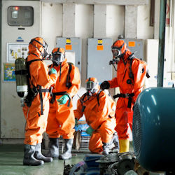 Group of four hazardous material specialists in full PPE