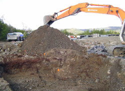 Backhoe removing soil carefully