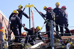 Rescue team helps pull someone from a confined space.