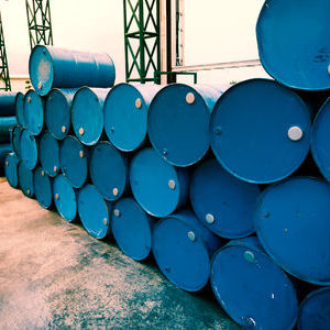 A number of blue barrels stacked on top of each other.