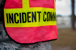 A close up photo of a safety vest. The title Incident Command is printed on the vest.