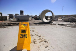 Hot Zone yellow folding sign sitting on a concrete pad.