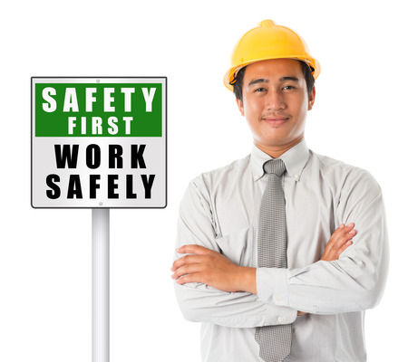 Image of a worker next to a sign that reads Safety First - Work Safely