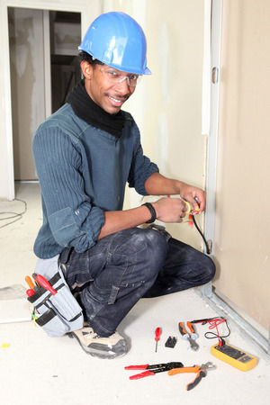 Image of a worker who is proud of the electrical work he is doing