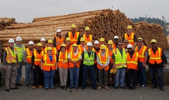 A whole crew of employees in safety vests having their photo taken