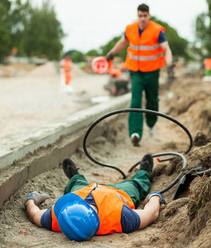 Safety committee member involved in accident investigation. Two men one laying in ditch one running towards him