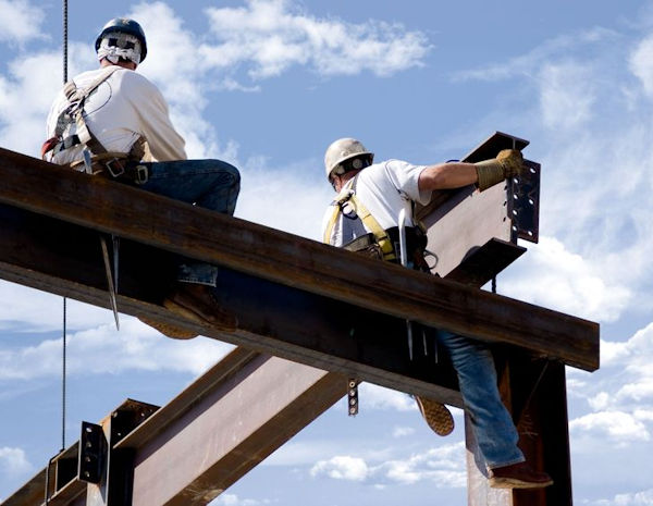 Two workers high on steel beams carelessly very likely to cause a terrible accident